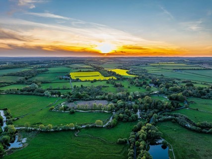 Sunset of Fields and Farms over Horsebridge nad Stockbridge from a drone, Hampshire, England,