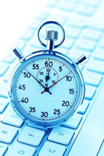 A stopwatch is placed on a computer keyboard. Office hours, timekeeping, stopwatch, Vienna, Austria
