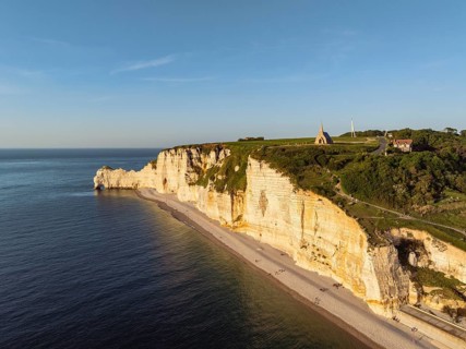 Aerial view of the Porte d'Amont rock formation and landmark, Falaise d'Amont in the evening sun