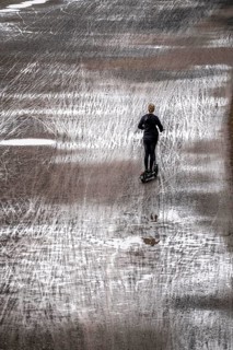 Dirt road, with many traces of two-wheelers, footprints, e-scooters, wet, after rain, parallel,