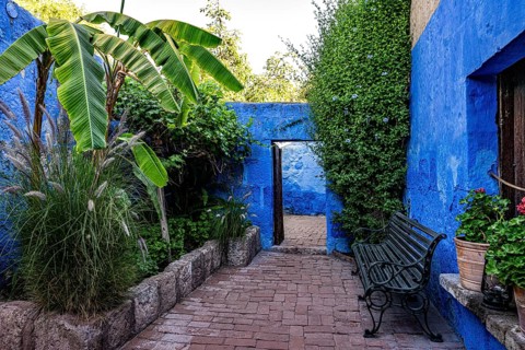 Small courtyard with bench, banana tree and plants in the monastery of Santa Catalina of the