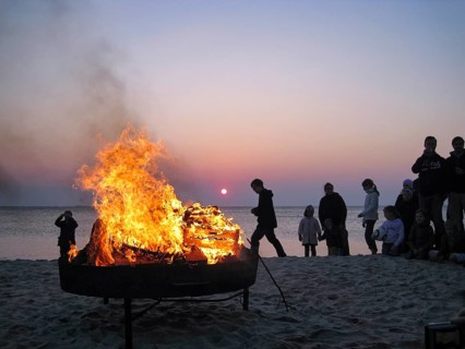 Easter bonfire, bonfire, on the beach, dark silhouettes, group of people at dusk, sunset, North