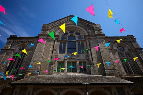 Colourful pennants, flags, sky, blue, behind former church, Falmouth, Cornwall, England, Great