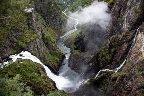 Majestic waterfall flowing through a narrow and lush gorge, Voringsfossen, with 165m drop, above