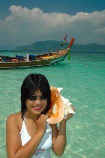 Thai woman with large mussel on her ear, Thailand