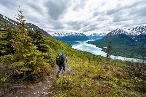Climbers on a hiking trail, Slaughter Ridge Trail, view of snowy mountains in spring and turquoise
