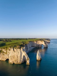 Aerial view of the Porte d'Aval rock formation in the evening sun, well-known sights on the chalk