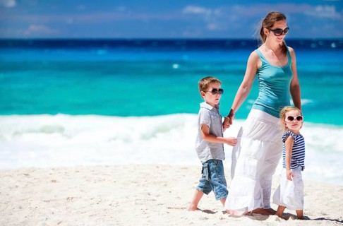 A young woman with two children, boy and girl, on the beach, Seychelles, La Digue, Indian Ocean,
