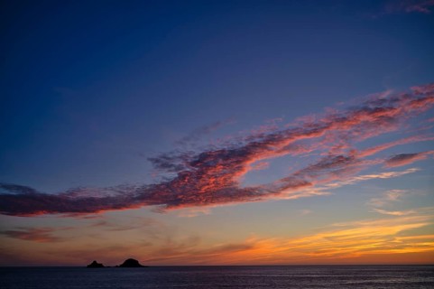 Sunset, sunset at sea, dramatic clouds, in the background rock formation The Brisons, Cot Valley