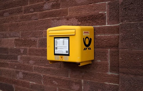 Letter box, mail box, yellow, on house wall, DHL, Deutsche Post, logo, Keplerstadt, Weil der Stadt,