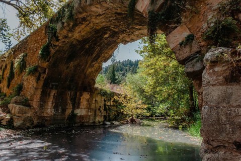 Greco-Roman Bridge across the river in Vrises, Crete, Greece, An old stone arch bridge over a
