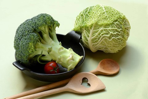 Savoy cabbage and broccoli with cooking spoon