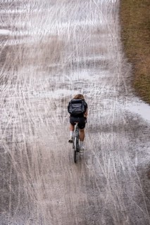 Dirt road, with many tracks of two-wheelers, footprints, wet, after rain, parallel, mixed up