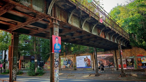 Görlitz railway bridge, rusty old bridge with posters and graffiti in an urban environment,