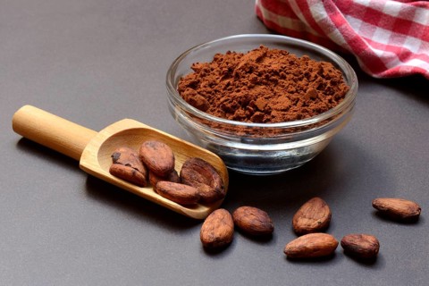 Cocoa powder in glass shell and cocoa beans