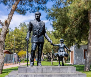 Antalya, Turkiye - April 14, 2025: Statue of Mustafa Kemal Ataturk holding childs hand in public