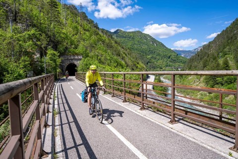 Two cyclists with panniers on a cycle path, cycle path along the old Pontebba railway line in the