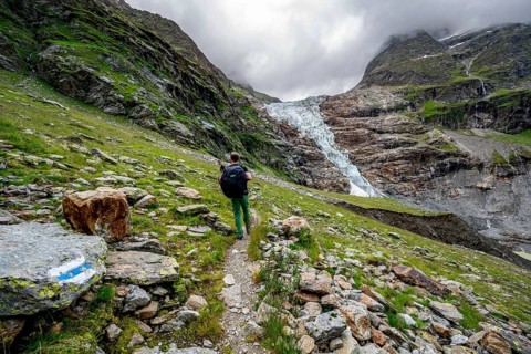 Mountaineers on a hiking trail, dramatic mountain landscape with Lower Arctic Sea glacier, Bernese