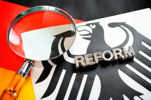 Reform and magnifying glass lettering on federal eagle and German flag, symbolic photo of German