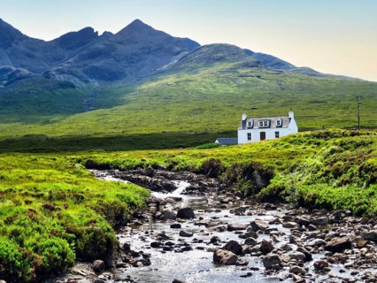Allt Dearg Cottage, River Sligachan, riverbed with rocks, Black Cuillin mountain range, blue sky,