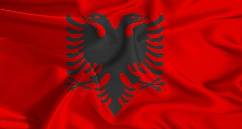 Colorful flag of Albania with a silky fabric texture waving. Realistic Albania flag waving