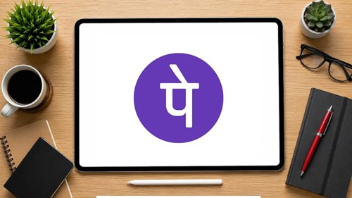 In this photo illustration, an iPad displays the PhonePe logo on a minimalist wooden office desk,