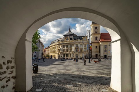 Passage to Pia?a Mare Great Square with City Hall and Holy Trinity Catholic Parish Church in Sibiu