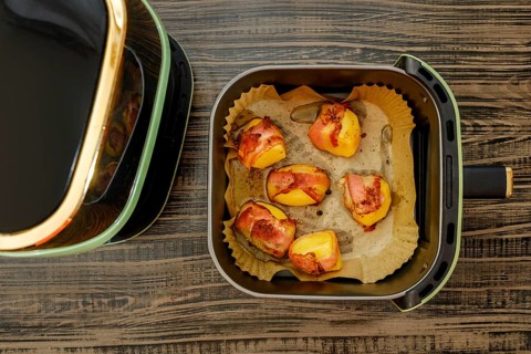 Top view of potatoes wrapped in bacon baked in air fryer