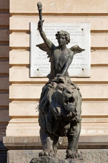 Winged boy riding on a lion, allegorical bronze sculpture in front of the Palazzo della Borsa,