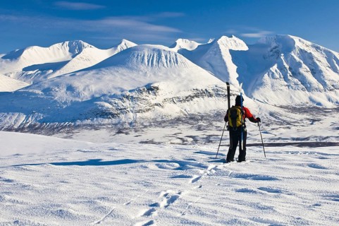 A ski tourer looks at Mount Akka Massif, Stora Sjöfallet National Park, Laponia World Heritage