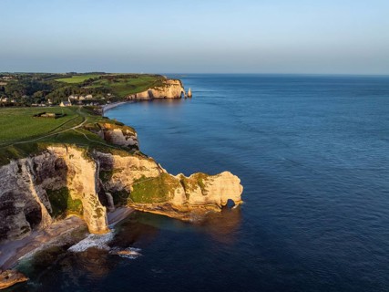 Aerial view of the Porte d'Amont rock formation, Falaise d'Amont shortly after sunrise, a landmark