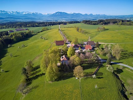 Horben viewpoint with castle and restaurant, snow-capped Alps and Mount Pilatus in the back,
