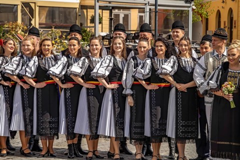 Wedding party in traditional dress on Little Ring Square or Pia?a Mica in the old town of Sibiu or
