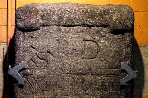 Weathered stone slab from the early medieval Govan Stones collection, later inscribed with the name