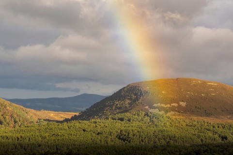 View through a rainbow from Cairngorm Mountain in the Hihglands in Scotland, Aviemore, Scotland,