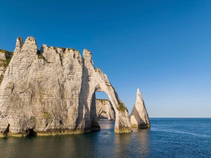 Aerial view of the Porte d'Aval rock formation with the free-standing Aiguille d'Étretat rock pin