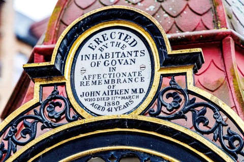 Close up of the gilded dedication plaque honouring Dr John Aitken on the Victorian memorial