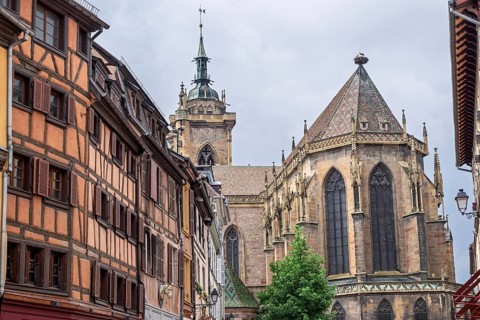 St. Martin Cathedral and half-timbered house facades, old town of Colmar, Alsace, France