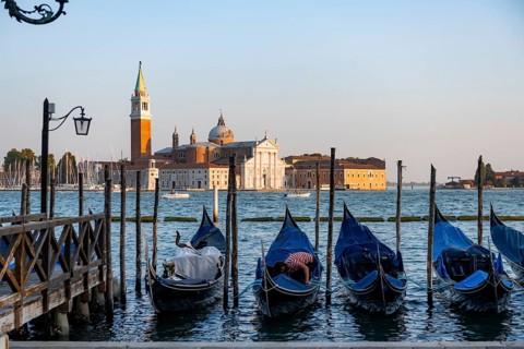 Venetian gondolas, boat launch at St. Mark's Square, San Giorgio Maggiore church in the evening