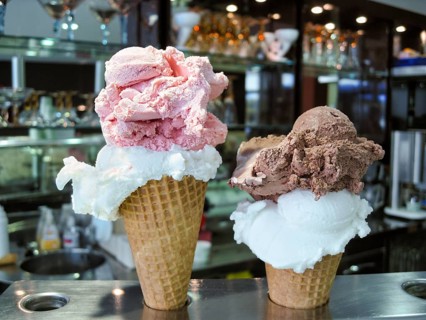 Two crispy ice cream cones, waffle cones with two huge scoops of creamy ice cream, various types,