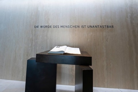 Table with an open book in front of an inspiring wall inscription, Parliament of Baden-Württemberg,