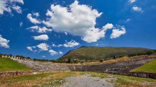 Ancient stadium, with green valley under blue sky with clouds, Messene Stadium, Ancient Site,