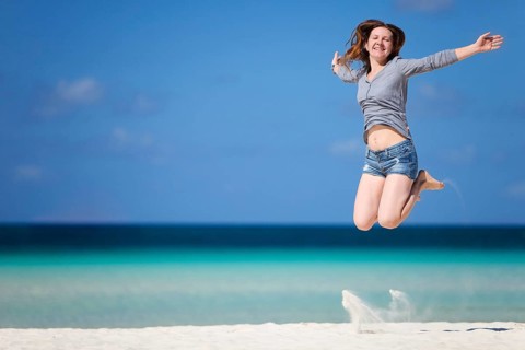 Vacation delights, a young woman jumping in the air for joy, beach, Boracay, Philippines, Boracay,