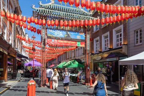 Red Chinese lanterns suspended over street in Chinatown, Gerard Street, Soho, London, England, UK