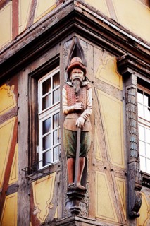 Merchant sculpture at Maison Zum Kragen timbered house, wood carving, Colmar, Haut-Rhin, Alsace,