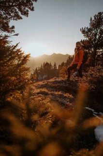 Hiker in the Allgäu at sunset in spring on the Zirmgrat near Pronten in the Allgäu