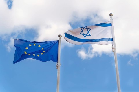 The national flag of the State of Israel and the flag of the European Union are waving against the