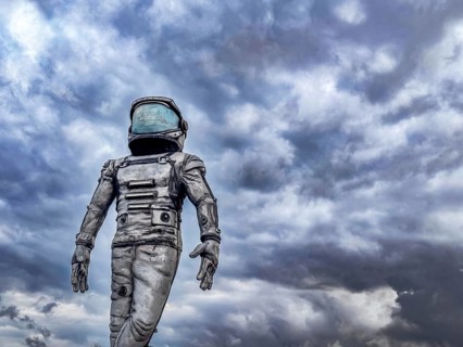 Antalya, Turkiye - 25.10.2025: An astronaut in a space suit stands against a cloudy sky. The scene