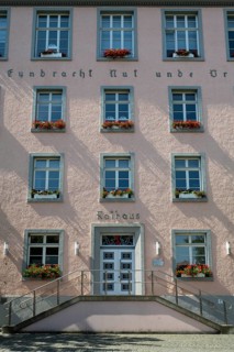 Façade of the town hall, east wing, flower boxes with geraniums in front of the windows, symmetry,