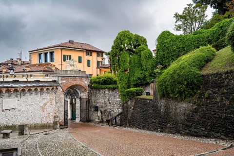 Entrance gate to Castello di Udine Castle, dramatic sky, old town, Udine, Friuli-Venezia Giulia,